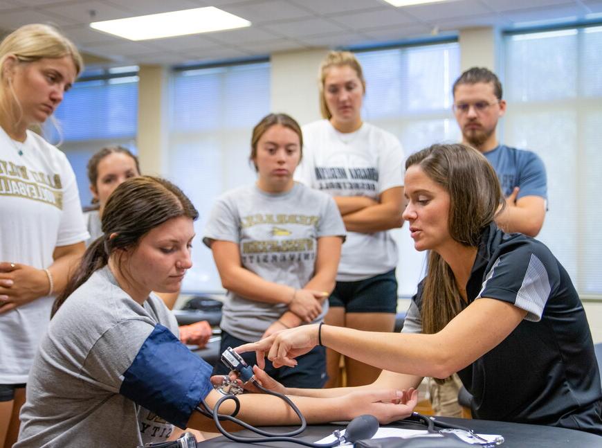 Samantha Wilson instructing students on bandaging